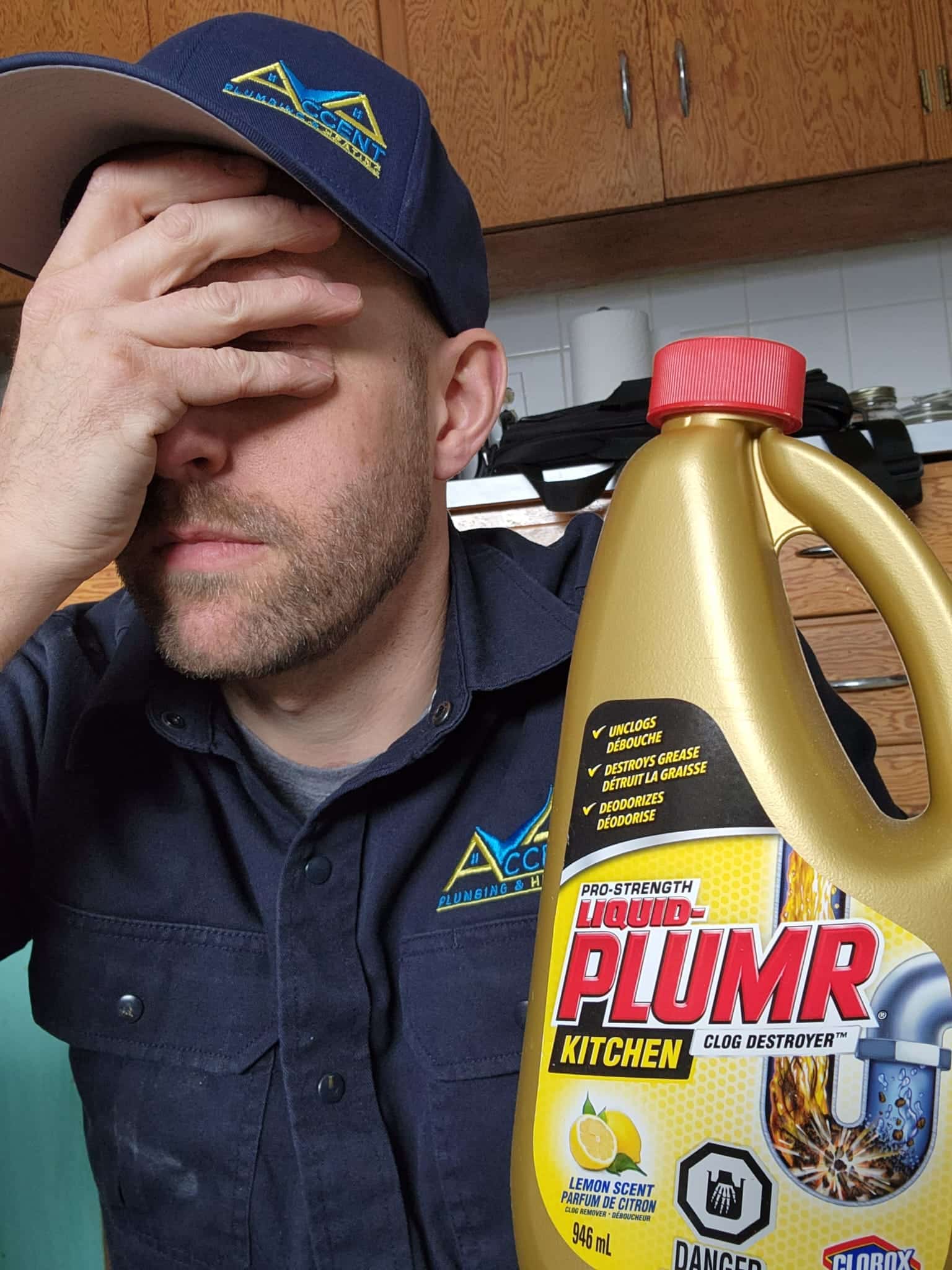 Ben from Accent Plumbing and Heating with a bottle of liquid drain cleaner